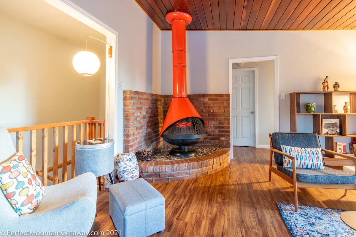 The main living room is a mix of real mid century modern furnishing and modern replicas, including this charming vintage fireplace (for design only - no wood burning).