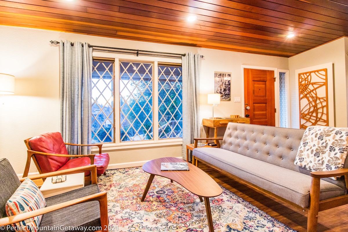 Cozy living room with mid-century modern furniture and a view.